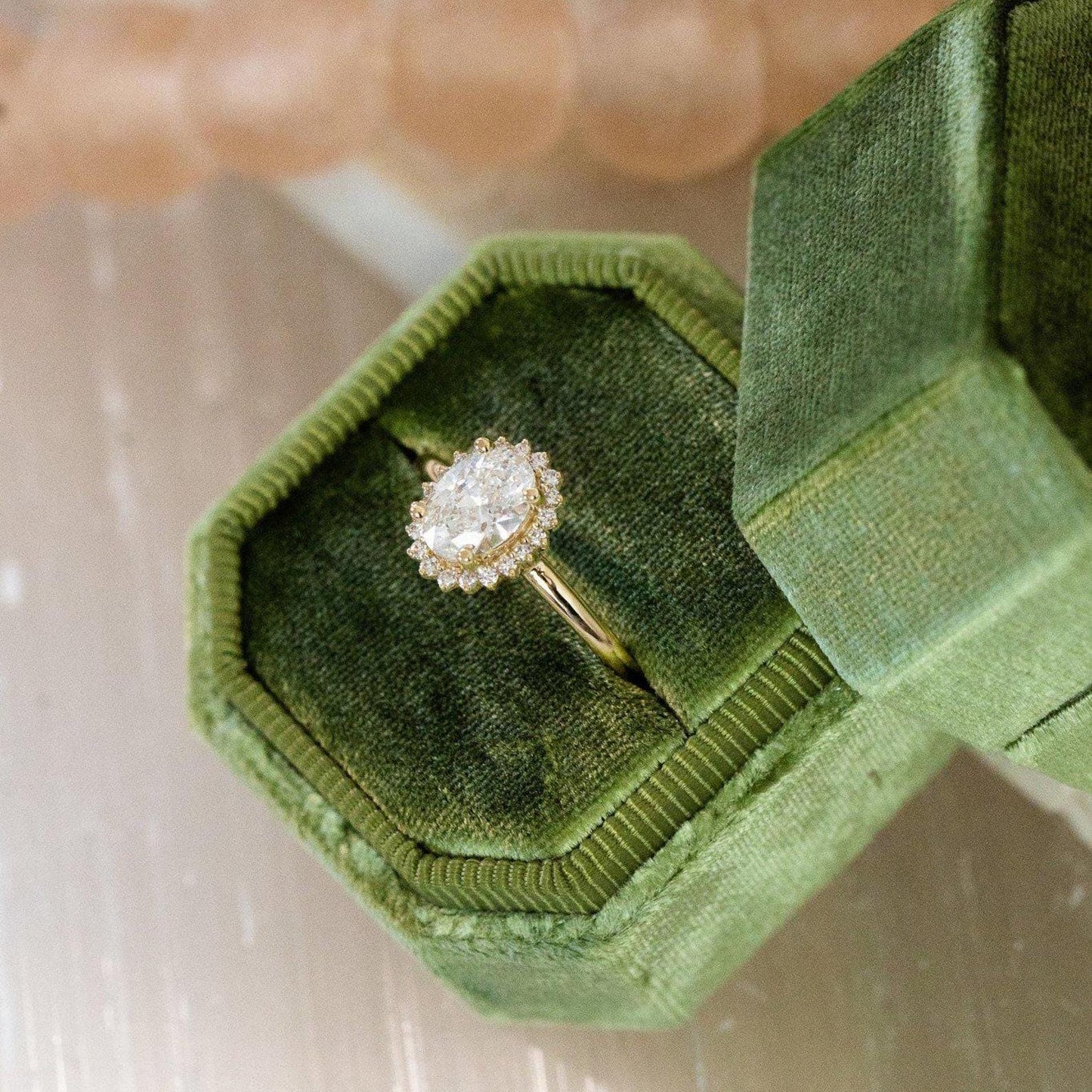 Halo-Style Engagement Ring with Oval Stone and Moissanite Side Stones