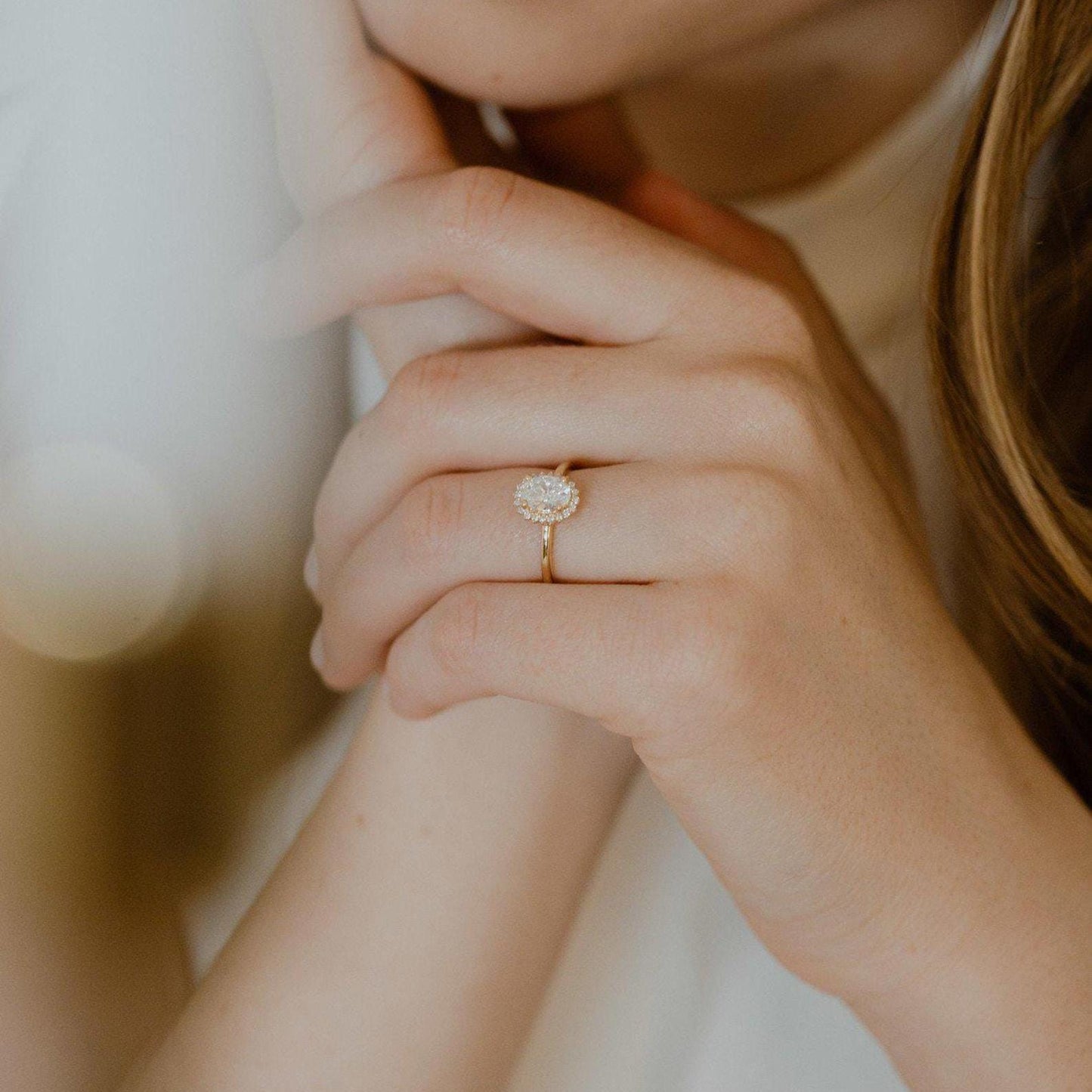 Halo-Style Engagement Ring with Oval Stone and Moissanite Side Stones