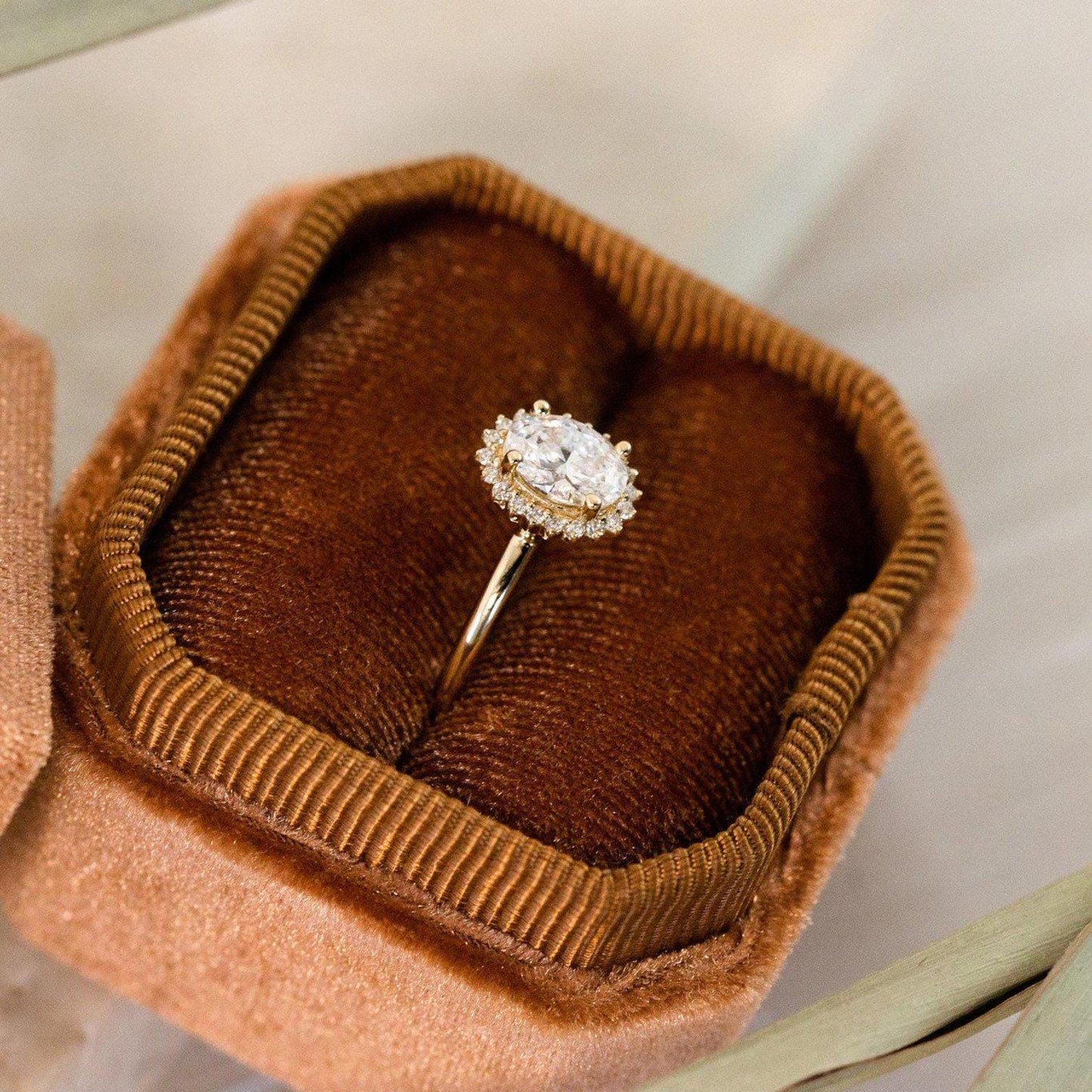 Halo-Style Engagement Ring with Oval Stone and Moissanite Side Stones