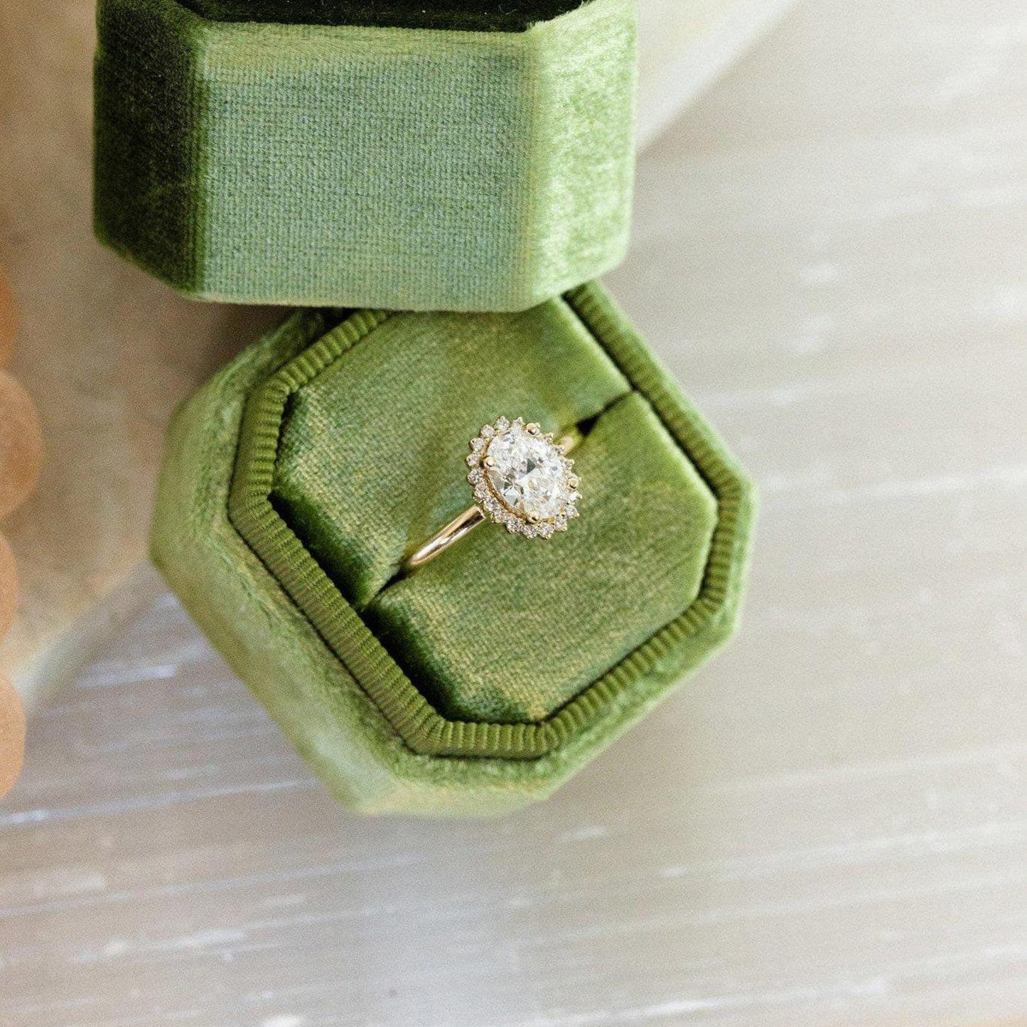 Halo-Style Engagement Ring with Oval Stone and Moissanite Side Stones