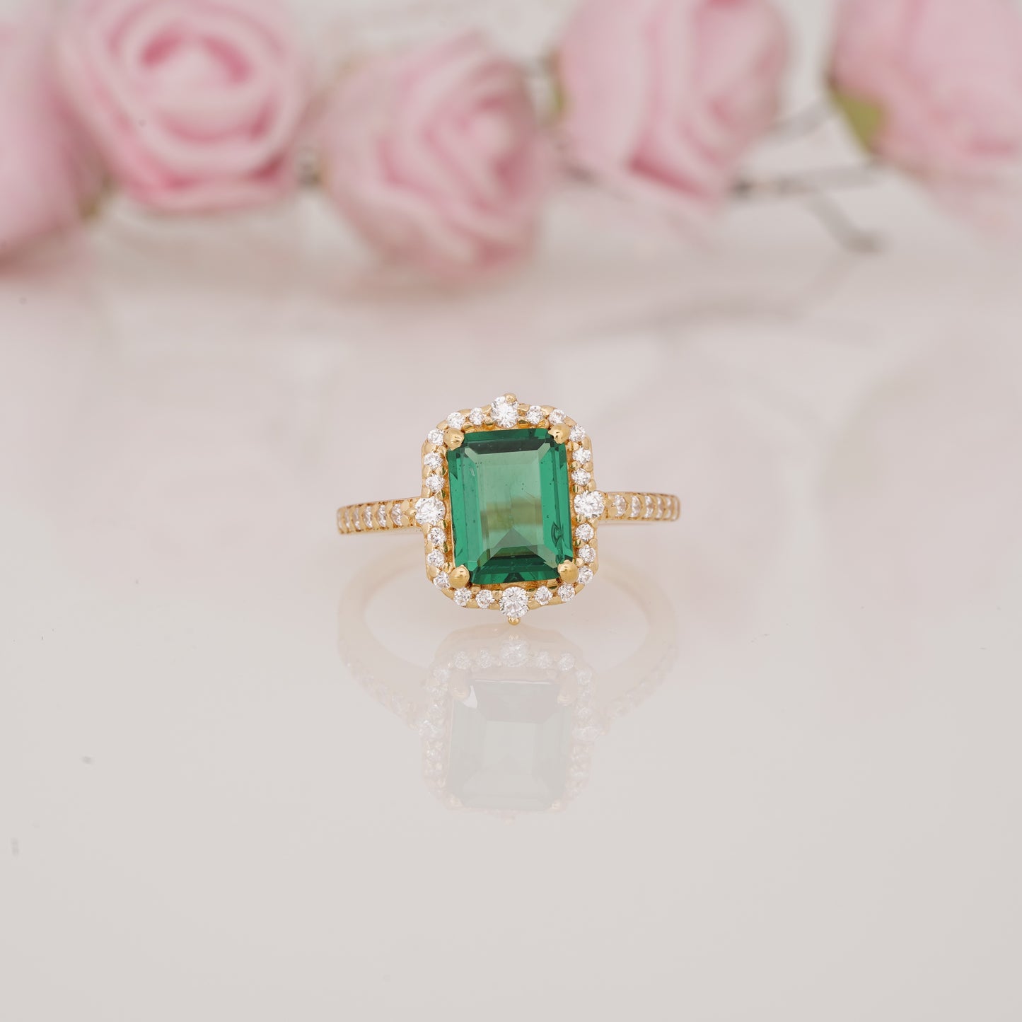 Halo-Style Engagement Ring with Emerald-Cut Emerald Stone and Moissanite Side Stones