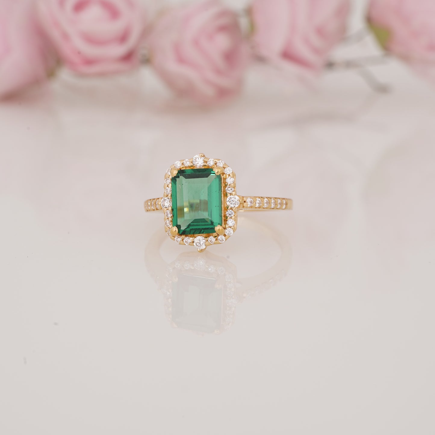 Halo-Style Engagement Ring with Emerald-Cut Emerald Stone and Moissanite Side Stones